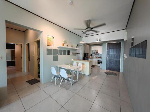 a kitchen and dining room with a table and chairs at Modern Comfy Suite Room-9Pax in Perai