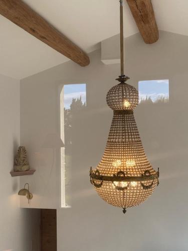 a chandelier hanging from a ceiling in a room at Villa Betty -piscine chauffée- in Paradou