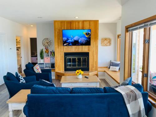 a living room with blue couches and a fireplace at The best lake view in Ozark. in Lake Ozark