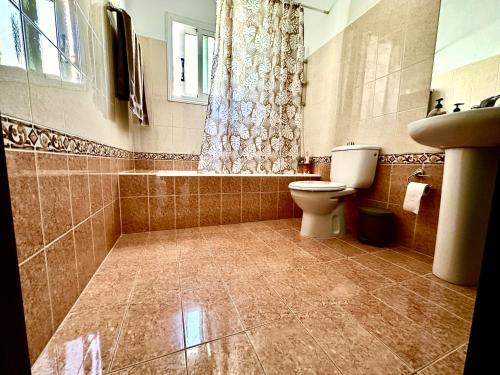 a bathroom with a toilet and a sink at Athena Two-bedroom Townhouse in Paphos City