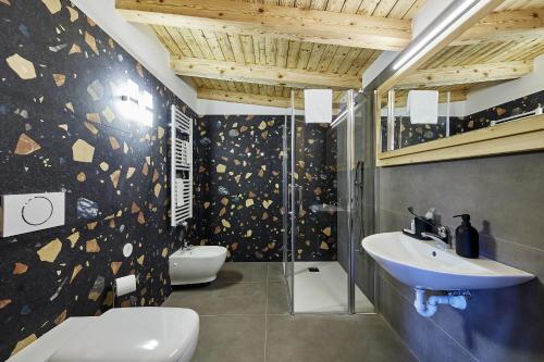 a bathroom with a toilet and a sink and a shower at Locanda Boton D'Oro in Auronzo di Cadore