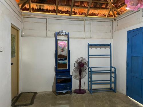 a room with two blue shelves and a fan at araliya villa in Kalpitiya