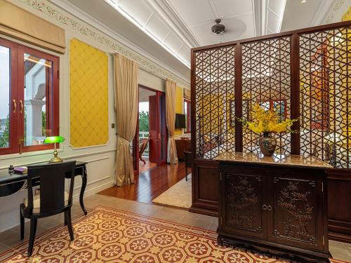 a room with a table and a desk in a room at Ancient Huế Garden Houses in Hue