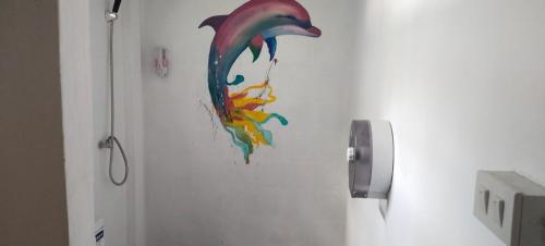 a painting of a fish on the wall of a bathroom at Lazy Hut in Ko Phayam