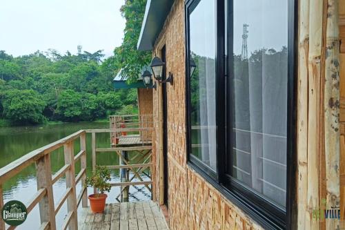 a balcony with a view of a river at Caliraya Ecoville Recreation and Farm Resort in Cavinti