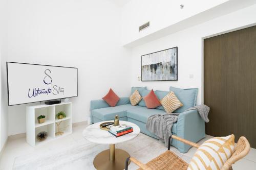 a living room with a blue couch and a table at Ultimate Stay / 5 min walk from Dubai Mall / 5 People / Downtown Boulevard in Dubai