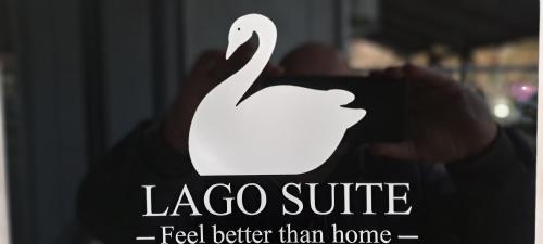 a logo of a white swan on a sign at Lago Suite in Kastoria