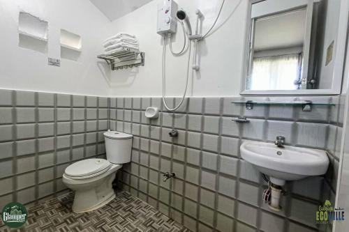 a bathroom with a toilet and a sink at Caliraya Ecoville Recreation and Farm Resort in Cavinti