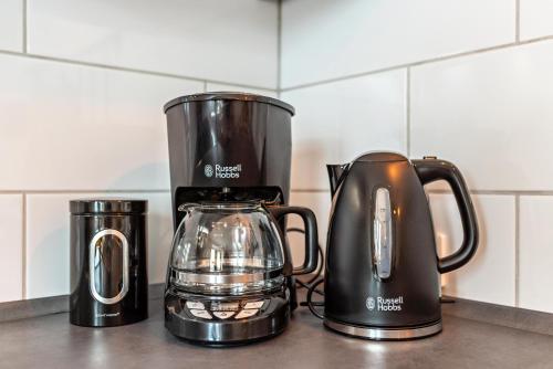 two kettles are sitting on a counter top at Haus Bergruh Kuckucksnest in Todtnauberg