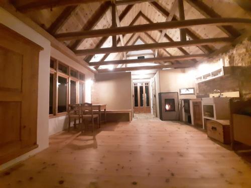 an empty room with a wooden floor and a table at Erlebnishof Bauernhof Ferienhaus 