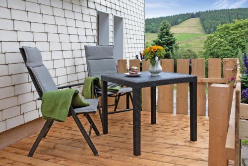 a table and two chairs on a patio at Haus Bergruh Kuckucksnest in Todtnauberg