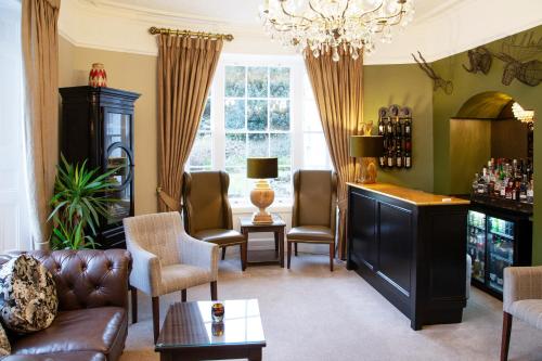 a living room with a couch and chairs at Haytor Hotel in Torquay