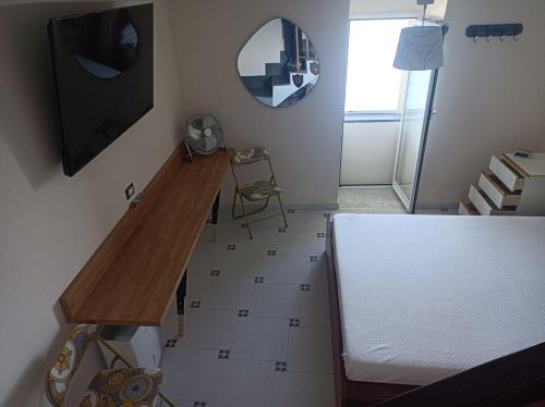 a room with a table and a mirror on the wall at Turchese in Amalfi