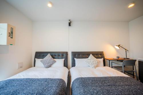 two beds sitting next to each other in a room at Minn Haneda Airport in Tokyo