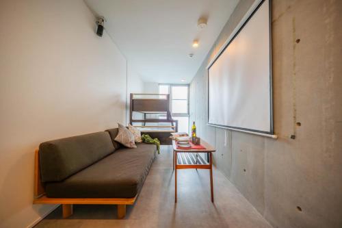 a living room with a couch and a table at Minn Haneda Airport in Tokyo