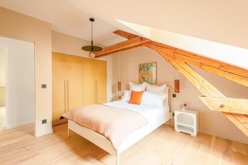 a bedroom with a white bed in a attic at Villa Marie in Dijon