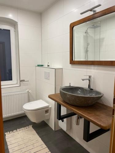 a bathroom with a sink and a toilet at Ferienwohnung in Weitersburg
