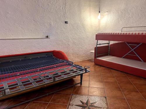 a red bunk bed in a room with a star on the floor at Olivetta House Holiday in Moneglia