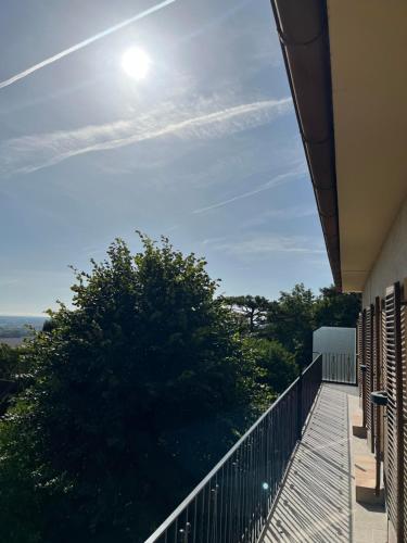 a balcony of a building with the sun in the sky at Almschlössl in Baden