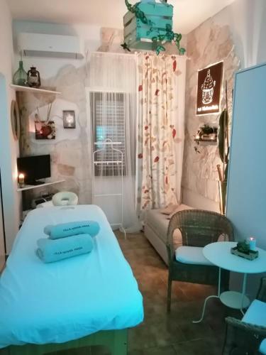 a room with two beds and a couch at B&B Villa Nonna Maria in Castellana Grotte