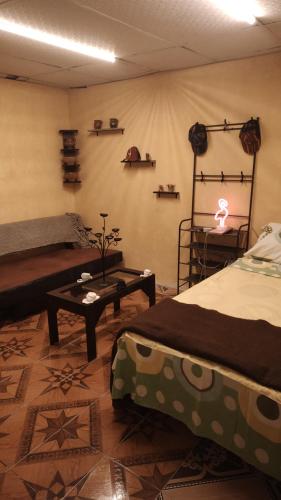 a room with two beds and a table in it at Santa Inés Antigua in Antigua Guatemala