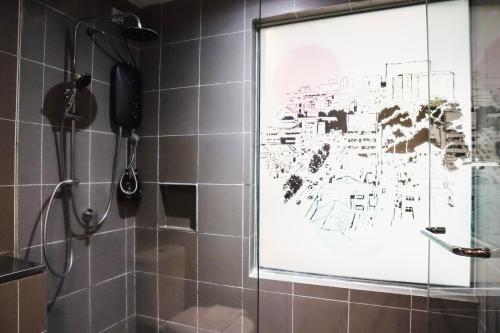 a painting on the wall of a shower in a bathroom at Homesuite' Home at Aeropod SOVO in Kota Kinabalu