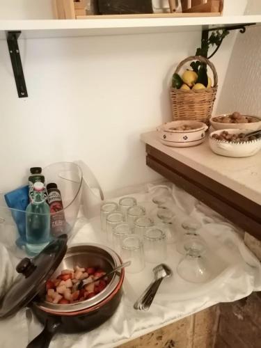 a kitchen counter with glasses and a bowl of food at B&B Villa Nonna Maria in Castellana Grotte