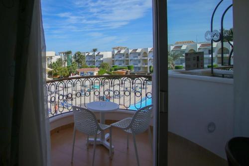 a view of a balcony with a table and chairs at Labranda Royal Makadi in Hurghada