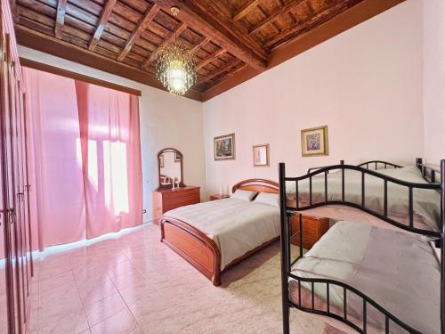 a bedroom with two bunk beds and a window at Casa Leandra in Civitavecchia