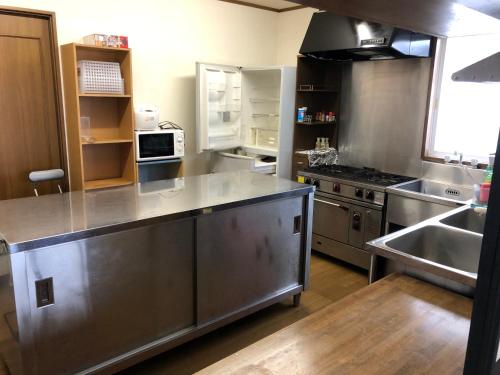 a kitchen with a large stainless steel counter top at The Bohemians' Shelter in Hakuba