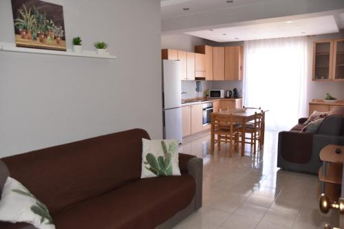 a living room and kitchen with a couch and a table at Panorama Beach House in Mascali