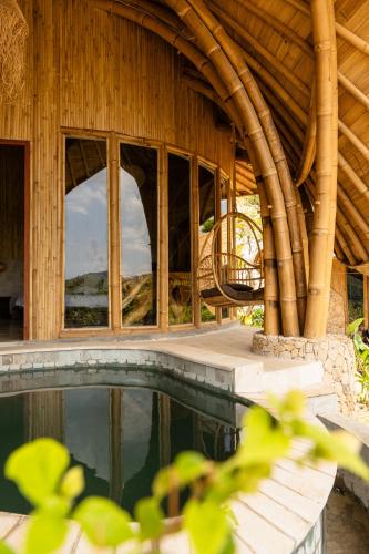 a house with a swimming pool and windows at Villa con Piscina Vista Mare - Lussuosa - Villa Chiara, Anima Eco Lodge in Selong Belanak