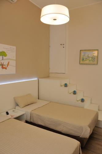 Letto o letti in una camera di Il Piccolo Principe B&B