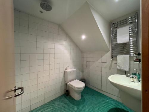 a bathroom with a toilet and a sink at Multi-Award Winning 7 Storey Home - Near Shoreditch in London