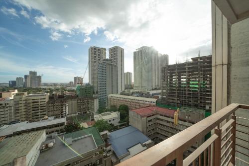 a view of a city from a balcony at KL Tower Makati Apartments by PH Staycation in Manila