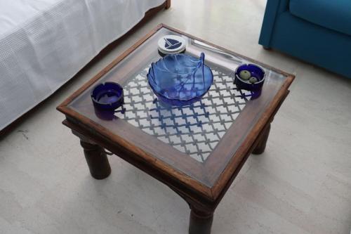 a chess board with blue bowls on it on a table at Gentle Breeze apartment in Kamena Vourla