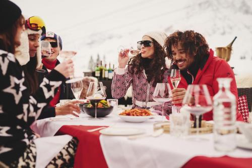 a group of people sitting at a table drinking wine at Burg Hotel Oberlech in Lech am Arlberg