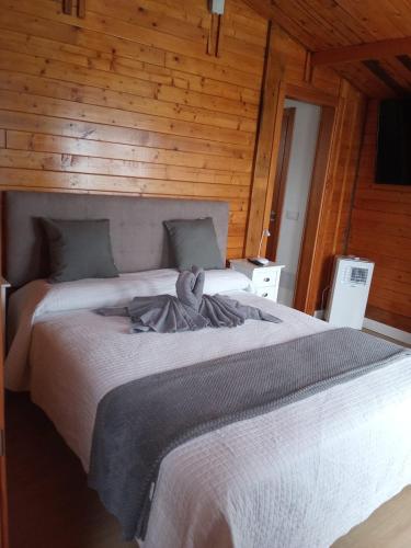 a bedroom with two beds with a stuffed animal on it at El Refugio in Guía de Isora