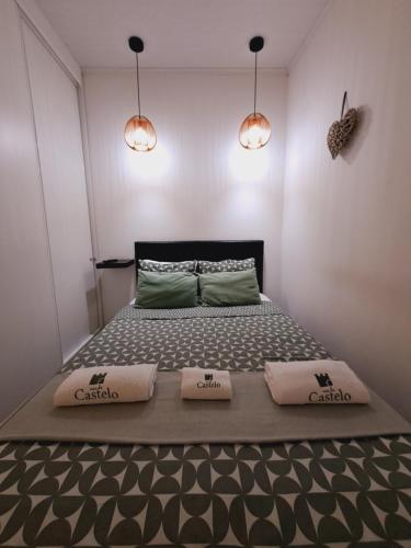 a bedroom with a bed with two pillows on it at Casa do Castelo in Tomar