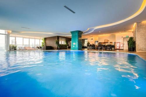 a large swimming pool in a hotel lobby at Modern Studio Apartment in Hanoi