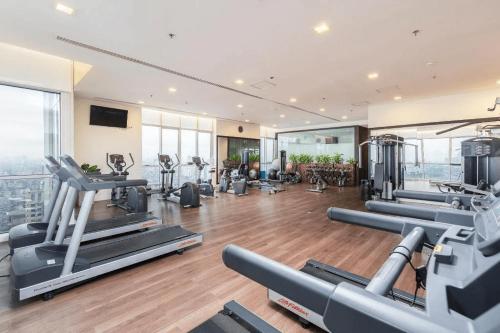 a gym with treadmills and exercise equipment in a building at Modern Studio Apartment in Hanoi