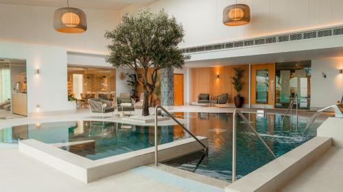 a house with a swimming pool with a tree in it at Dunboyne Castle Hotel & Spa in Dunboyne