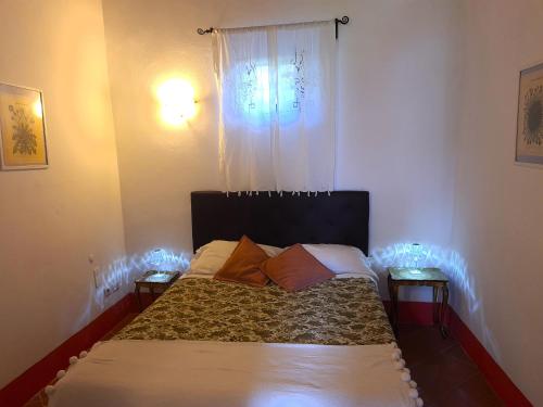 a bedroom with a bed and two night stands at B&B Le Torri Di Firenze in Fiesole