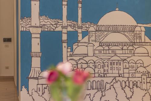 a wall with a drawing of a mosque at Palazzo Spada - Appartamento Cigno con 2 camere da letto in Codigoro