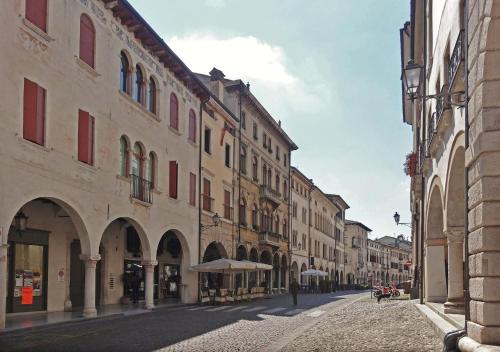 an empty street in a city with buildings at Centralissimo con vista colline in Conegliano