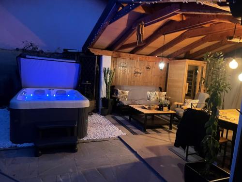 a large outdoor living room with a large screen tv at Villa Noa jacuzzi & sauna in Izola