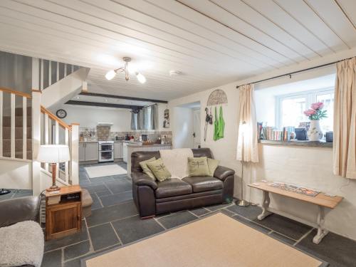 a living room with a couch and a table at Blaenfforest Granary Newcastle Emlyn in Capel-Ifan