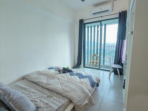 a bedroom with a bed and a large window at Modern Comfy Suite Room-9Pax in Perai