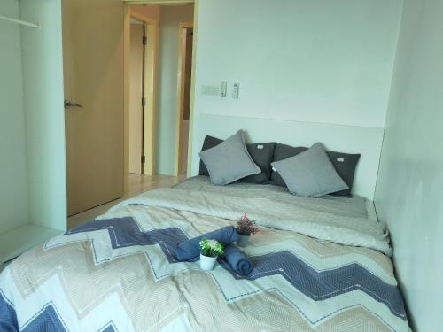 a bedroom with a bed with a potted plant on it at Modern Comfy Suite Room-9Pax in Perai