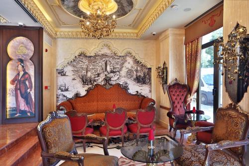 a living room with a couch and chairs and a chandelier at Daru Sultan Hotels Galata in Istanbul